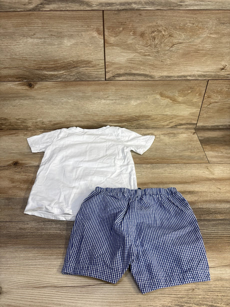 Back view of toddler tee and blue gingham elastic-waist shorts set laid flat on wood background