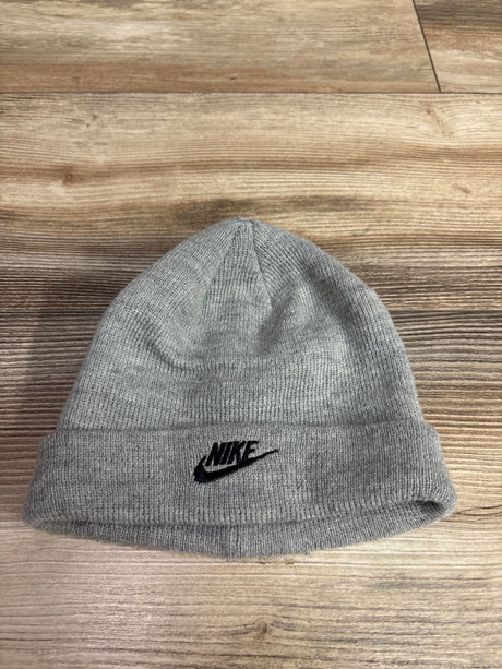 Front view of Nike knit beanie showcasing a black Nike swoosh logo with a wooden background