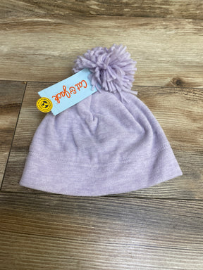 Light purple winter hat with pom pom on a wooden floor, featuring Cat & Jack brand tag