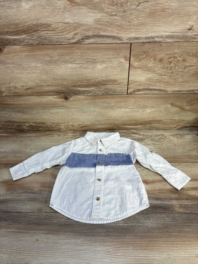 White long sleeve kids shirt with blue stripe and buttons, laid on wood surface