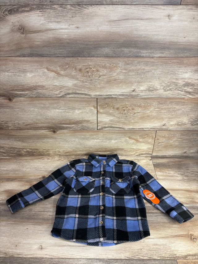 Blue and black plaid flannel long sleeve toddler shirt with front pockets on wood background