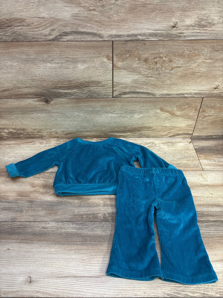 Top-down view of Cat and Jack two-piece blue velvet shirt and pants set for 12 months showing ribbed texture on a wood-look background