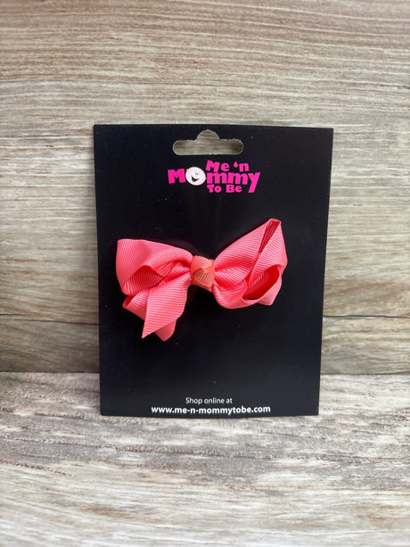 Solid coral hair bow from Me n Mommy To Be on a black display card
