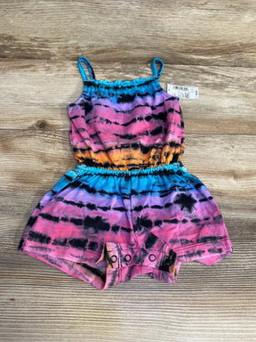Top-down view of Children's Place tie-dye baby romper with elastic waist, spaghetti straps and snap crotch on wood background