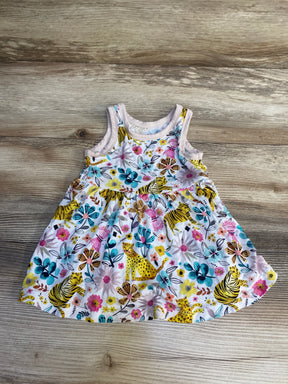 Toddler sleeveless dress with colorful floral and wild animal print on wood background