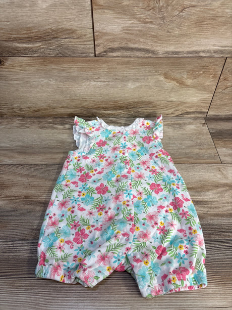 Flat lay of white Little Me shortie romper with pink and blue floral and flamingo print, button front and ruffle sleeves on wood