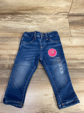 Blue toddler denim legging jeans with elastic waistband and pink label on wooden floor