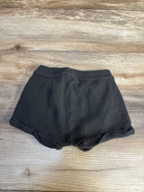 Black ribbed baby shorts on wood floor, kids clothing resale