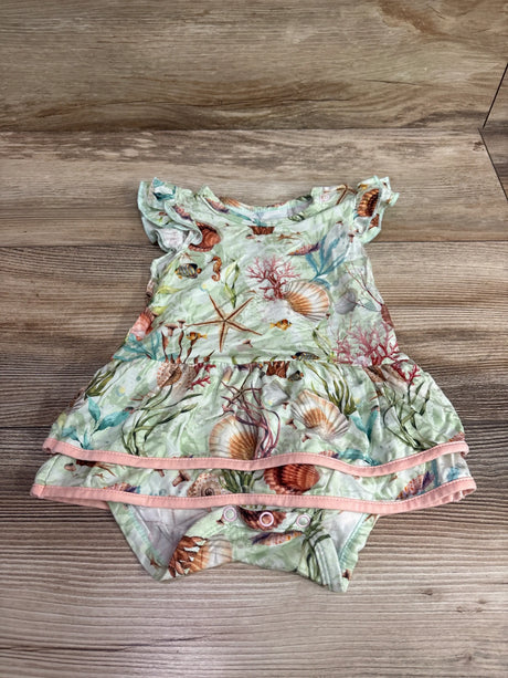 Front view of green sea animal bamboo bodysuit twirl dress showcasing pink trim and snap closures on a wood surface