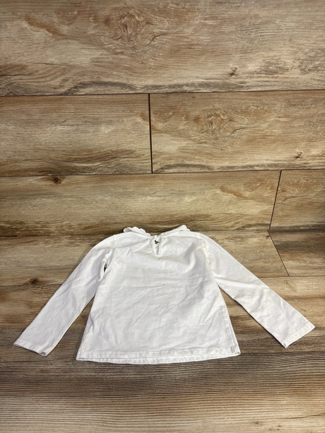 Back view of Oshkosh white long-sleeve toddler shirt (4T) showcasing scalloped collar and keyhole button closure, laid flat on wood floor