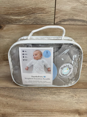 Dreamland Baby weighted transition swaddle in package for infants, gray, on wood surface