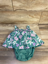 Front view of green floral toddler bodysuit dress with snap closures and ruffled skirt on white background
