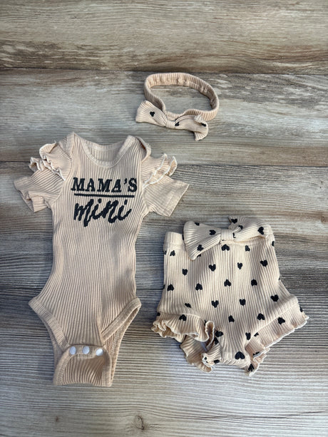 Beige baby outfit set with ruffled onesie reading 'Mama's mini', polka dot shorts, and headband