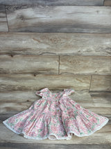 Front flat lay of girls Joie floral tiered dress size 3T showing button-front, ruffled cap sleeves, tiered skirt and lace trim on wood floor