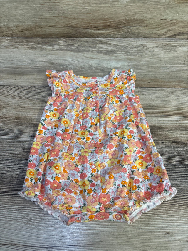 Front view of Carter's white floral shortie romper (3M) showing ruffled cap sleeves, snap crotch, lace-trim elastic legs on wood background