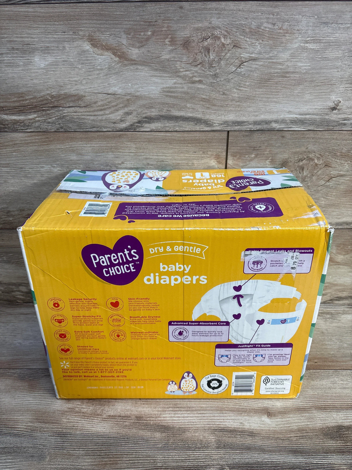 Box of Parent's Choice baby diapers on wood background, featuring diaper features and size guide.