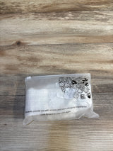 Clear plastic bag with baby items icons, placed on wooden surface, for kids and maternity resale shopping.