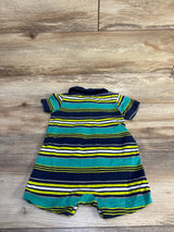 Back view of Simple Joys striped polo shortie romper showing navy, teal, white and yellow horizontal stripes with polo collar on wood background