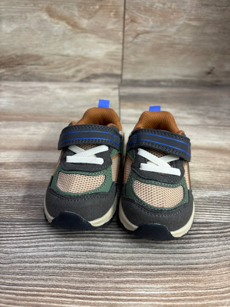Front view of brown Wonder Nation Chunky Jogger sneakers with hook-and-loop straps and white laces on a wood-grain surface