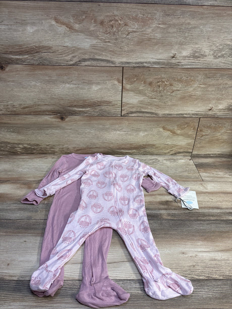 Top-down view of two Cloud Island footed sleepers (2-pack) in pink modal blend, one solid and one balloon-print, on wood background
