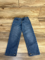 OshKosh kids denim jeans with elastic waist, laid flat on wood floor for resale