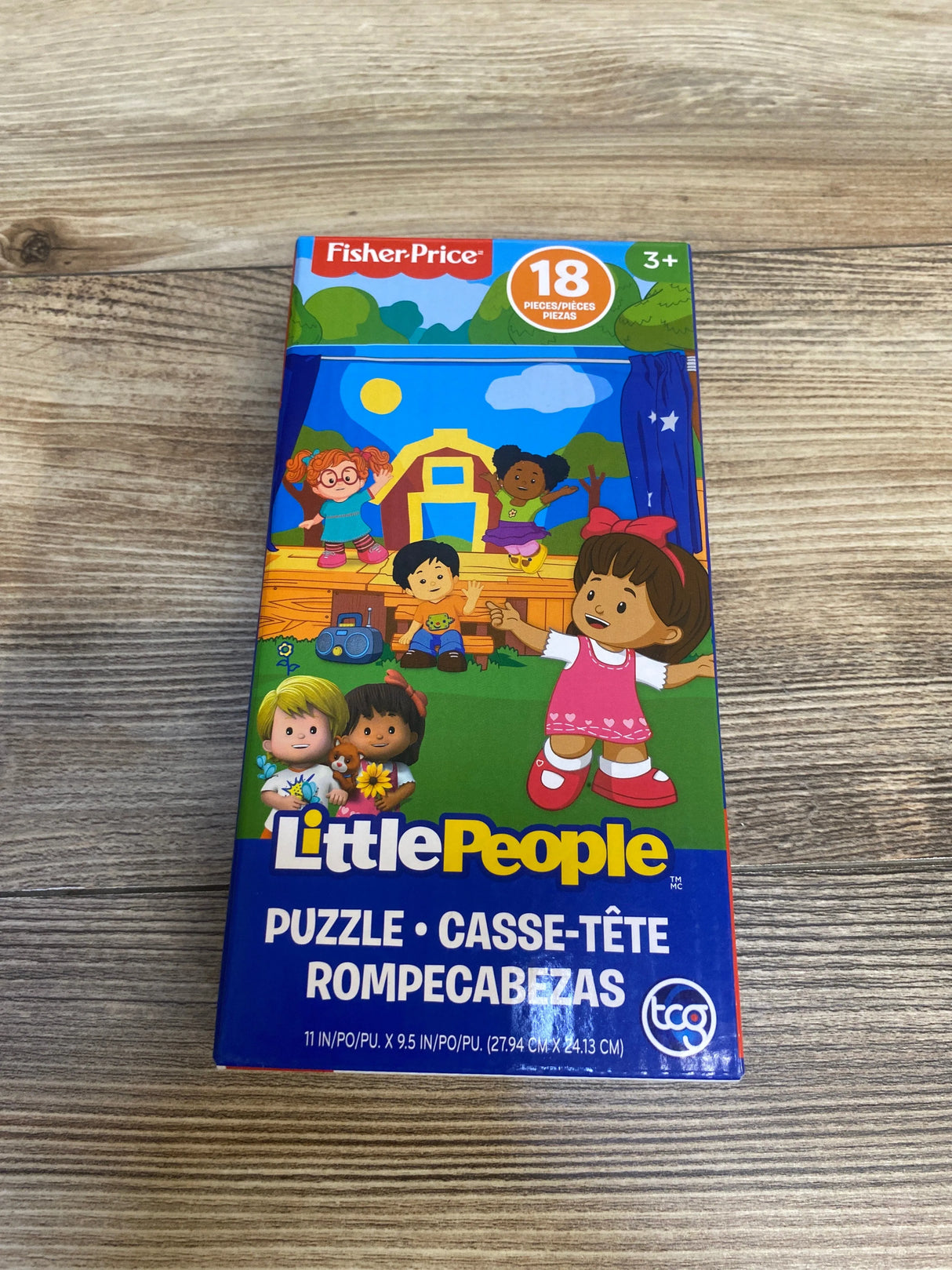 Fisher-Price Little People 18-piece puzzle box for kids ages 3 and up on wood surface
