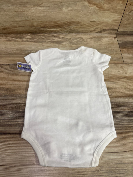 Back view of white Bee Silly baby bodysuit for ages 6 to 12 months with short sleeves on a wood grain surface