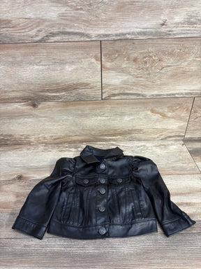 Black leather toddler jacket with button closure and puff sleeves on wooden floor