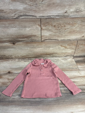Pink ribbed long-sleeve toddler top with peter pan collar and buttons on wooden floor