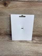 Front view of white birthday hair bow packaging showing attached silver alligator clip on wood background
