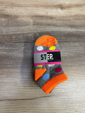 Pack of three colorful toddler socks with polka dots, labeled Step Up size 0-12, on wood surface