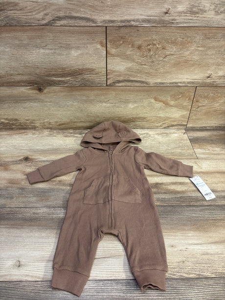 Front view of Carter’s brown waffle knit hooded coverall showcasing zip front and pockets on a wood grain background
