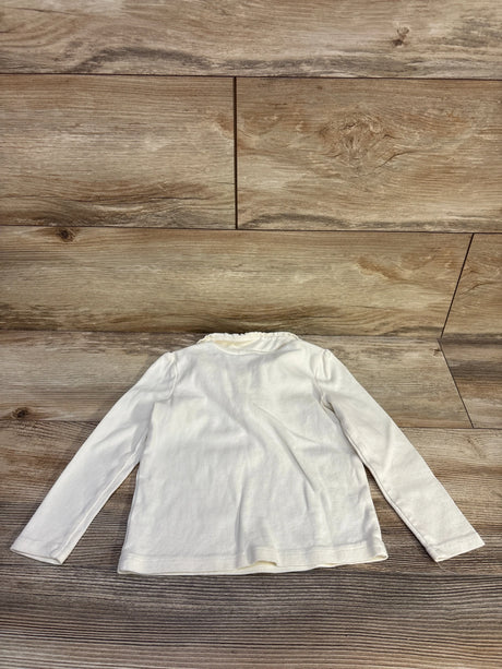 Back flat lay of Gymboree cream long sleeve toddler top showing ruffled Peter Pan collar on wood floor background