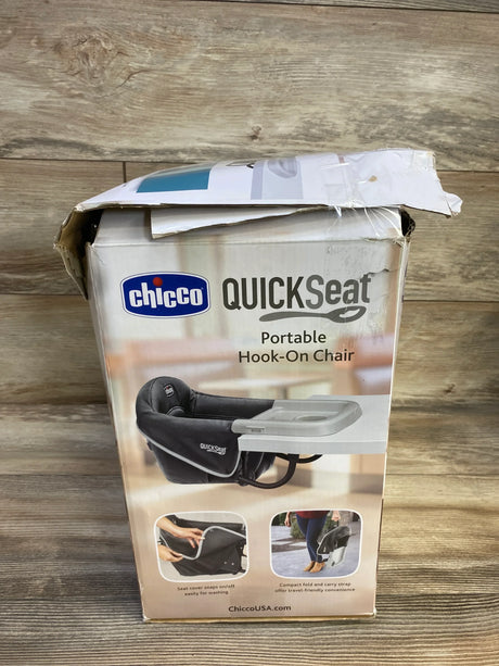 Front view of Chicco QuickSeat portable hook-on chair showing teal chair with attached tray on wood background