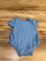 Light blue Nike baby bodysuit size 6m laid flat on a wooden surface