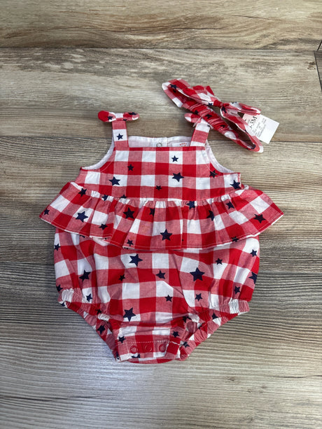 Top-down view of red gingham bubble romper with navy star print and matching headband showcasing ruffle waist and snap crotch on wood background