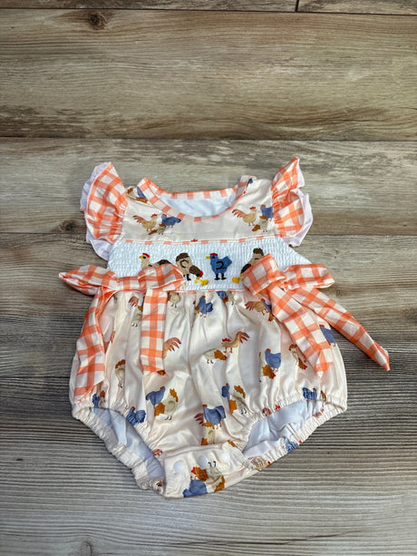 Top-down view of ivory bubble romper with smocked chest, embroidered roosters, orange gingham bows and flutter sleeves on wood, size 12-18 months
