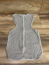 Front view of Love To Dream Swaddle Up Original gray swaddle showcasing front zipper and striped trim with wood floor background
