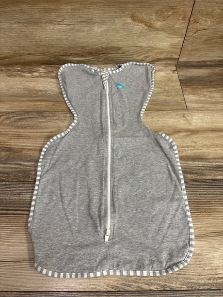 Front view of Love To Dream Swaddle Up Original gray swaddle showcasing front zipper and striped trim with wood floor background