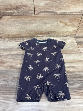 Flat lay of grey shortie baby romper showcasing palm tree print, short sleeves and snap crotch on wood background