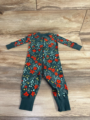 Green baby sleeper with red floral print and zipper, laid flat on wood floor