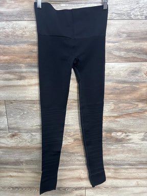 Black high-waisted maternity leggings on wood background