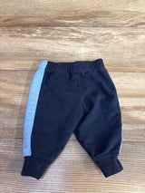 Black and blue baby pants with elastic waistband on wood background
