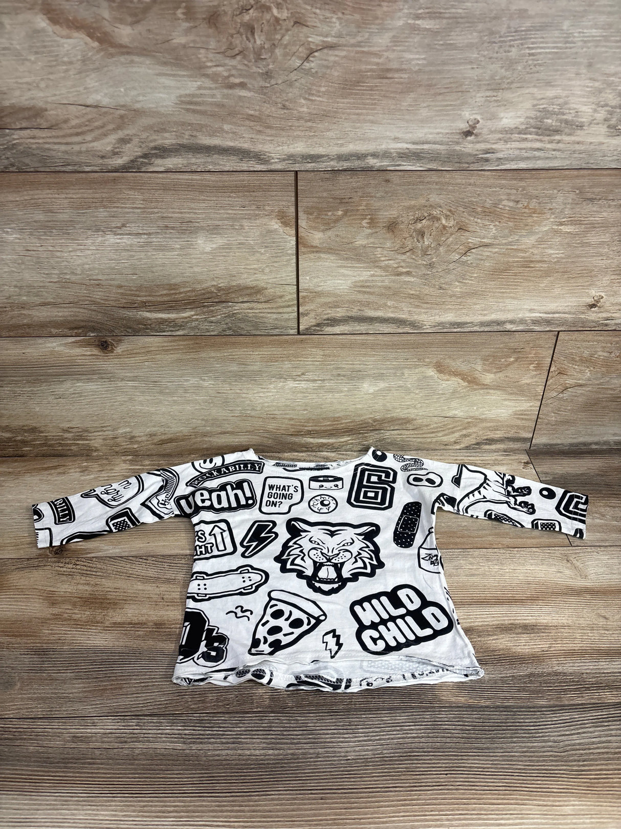 Long sleeve toddler shirt with black and white graphic prints including tiger, pizza, and slogans