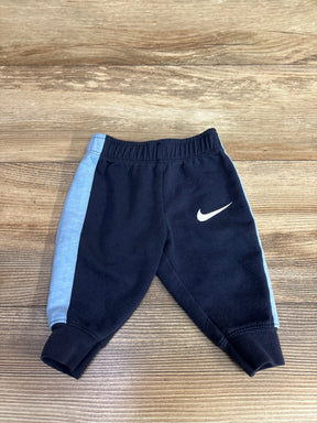 Black and light blue baby sweatpants with white logo on wooden background