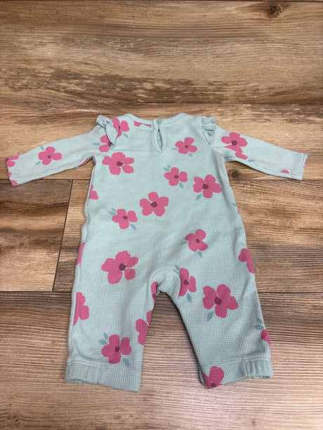 Front view of Just One You blue waffle knit coverall showcasing pink floral print and long sleeves on a wood floor