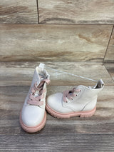 Front three-quarter view of Cat and Jack Amaya zipper combat boots with pink laces and pink lug sole on wood floor