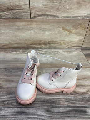 Front three-quarter view of Cat and Jack Amaya zipper combat boots with pink laces and pink lug sole on wood floor