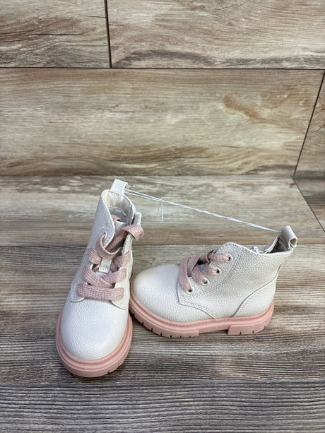 Front three-quarter view of Cat and Jack Amaya zipper combat boots with pink laces and pink lug sole on wood floor