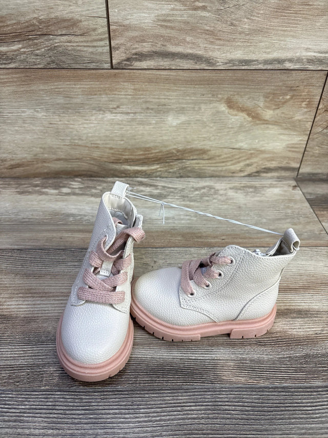 Front three-quarter view of Cat and Jack Amaya zipper combat boots with pink laces and pink lug sole on wood floor